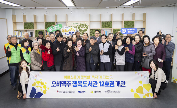 20일 청주시노인종합복지관에서 오비맥주 행복도서관 12호점 개관식을 마치고 기념사진을 찍고 있다.(사진=오비맥주)